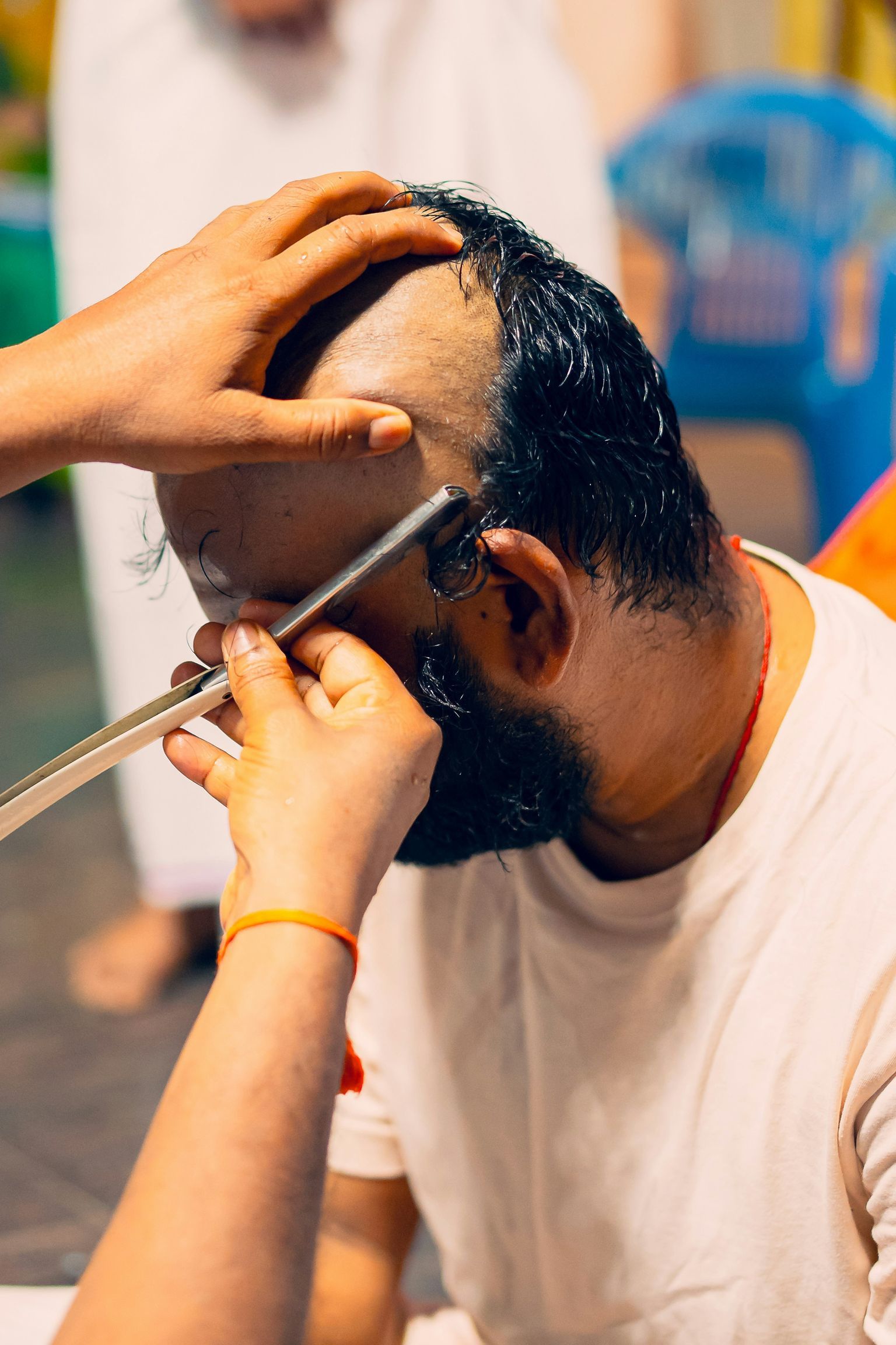 A man getting his hair cut at a barber shop